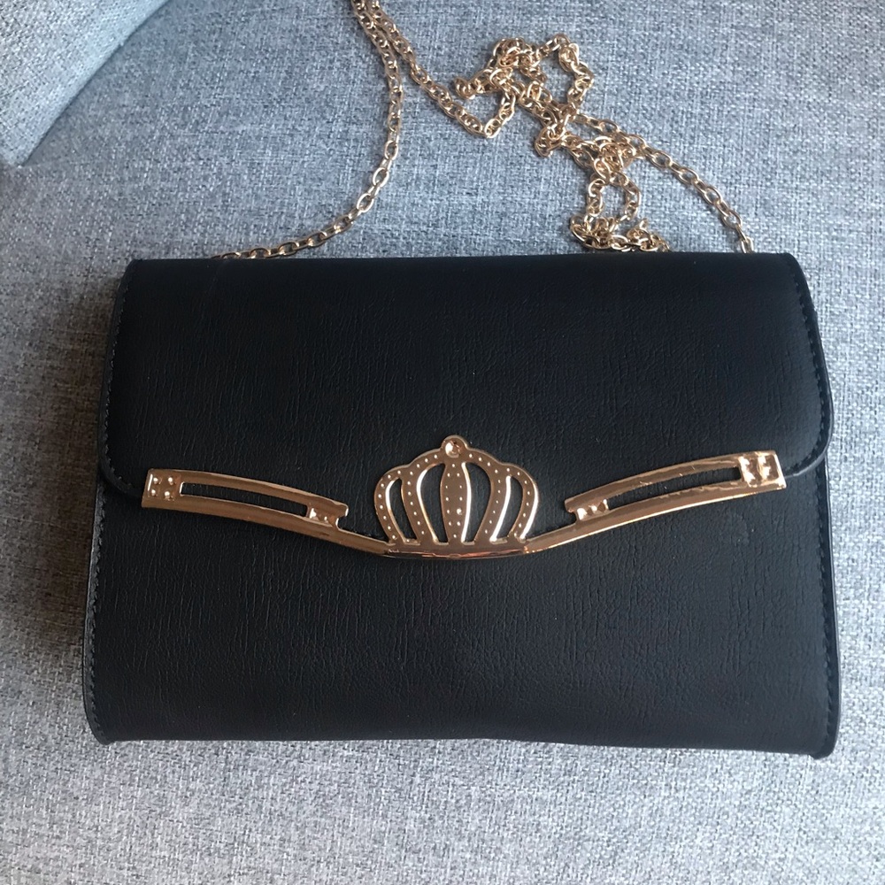 Black Cross-body and Clutch Purse with a Princess 👑 emblem in the center.